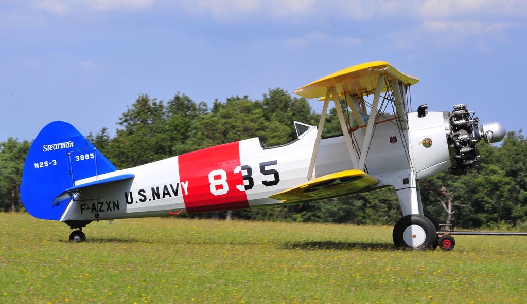 U.S. Navy Stearman, silver fuselage, yellow wings, blue tail surfaces ... seen here is F-AZXN